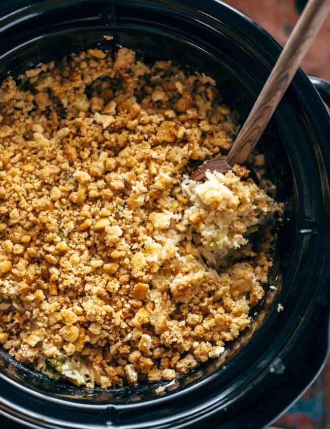 A crock pot full of granola with a wooden spoon, but replace "granola" with "velveeta" and "wooden spoon" with "broccoli rice casserole.
