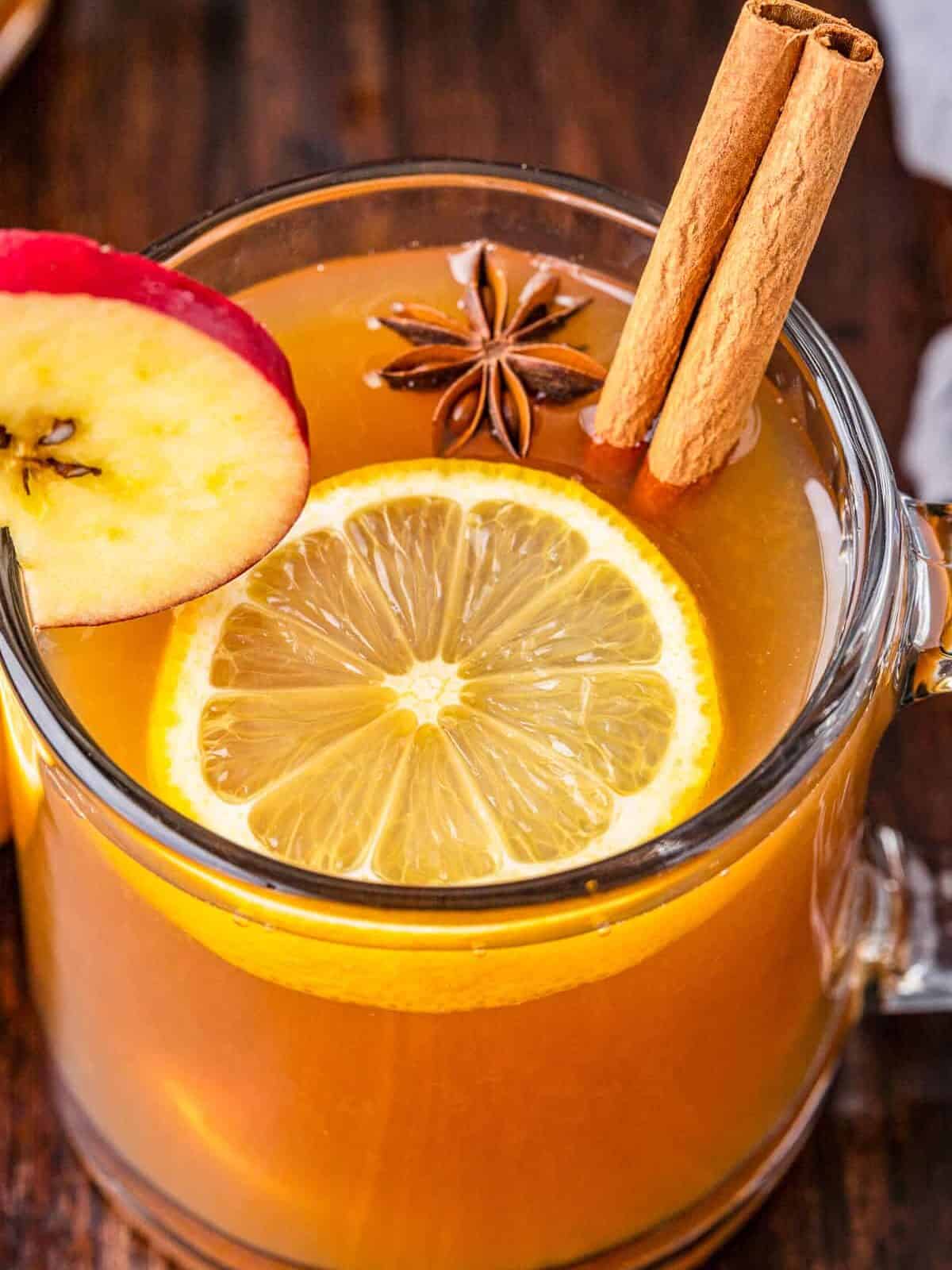 up close apple cider hot toddy with lemon and cinnamon