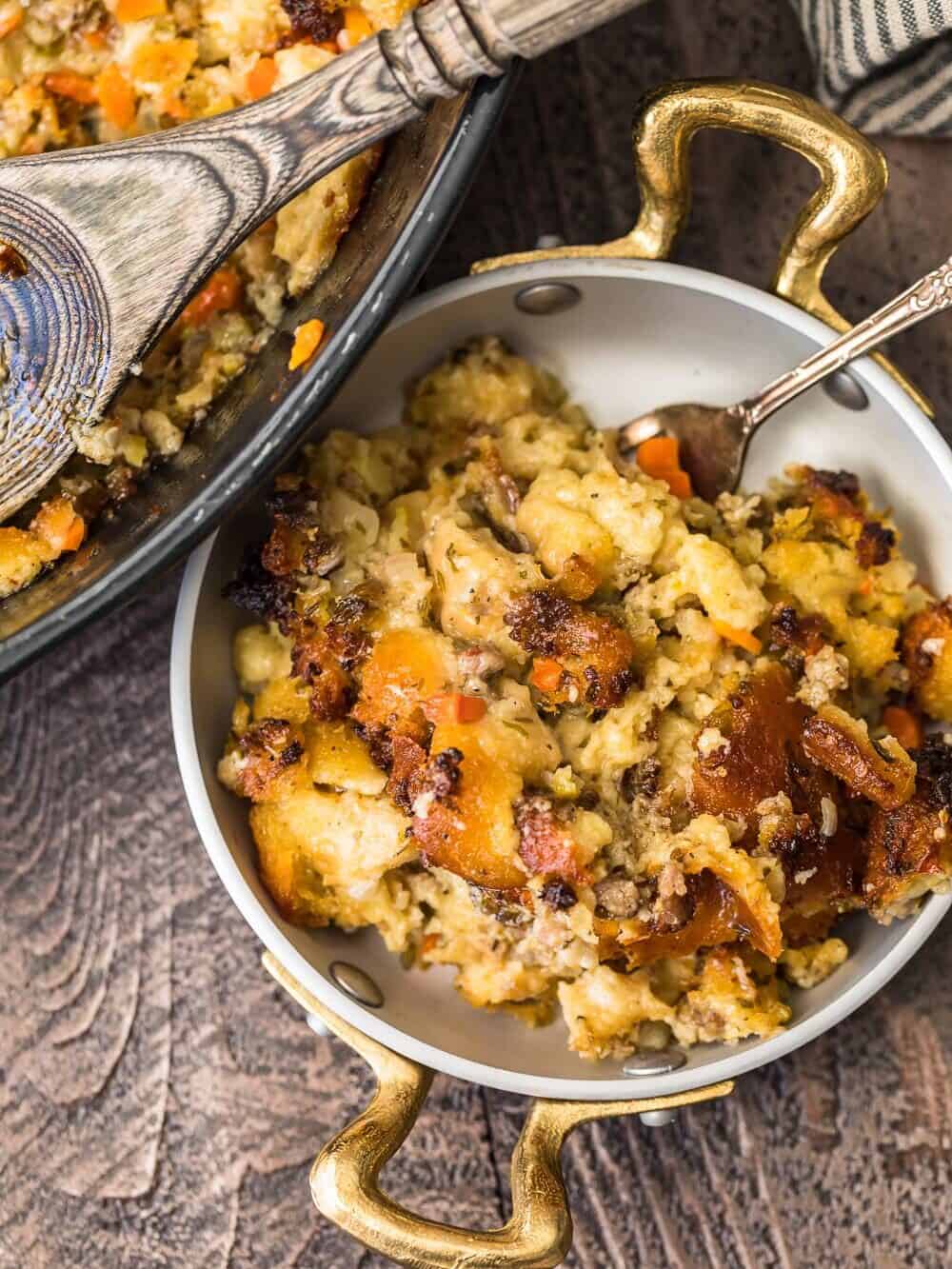 Sausage stuffing cooked with a spoon in a pan.