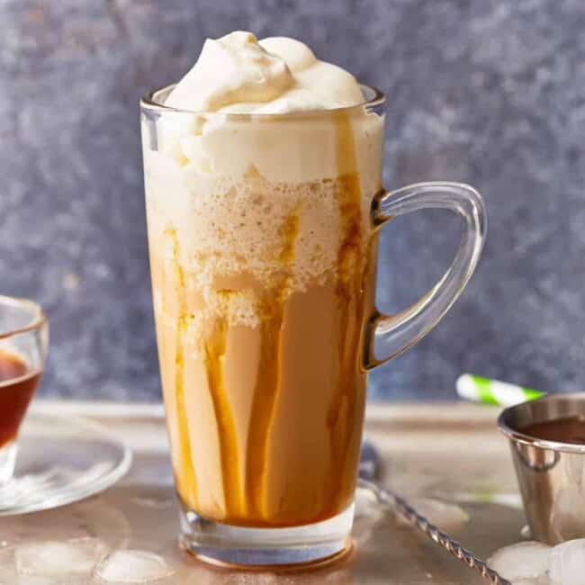 A cup of coffee with whipped cream and caramel.