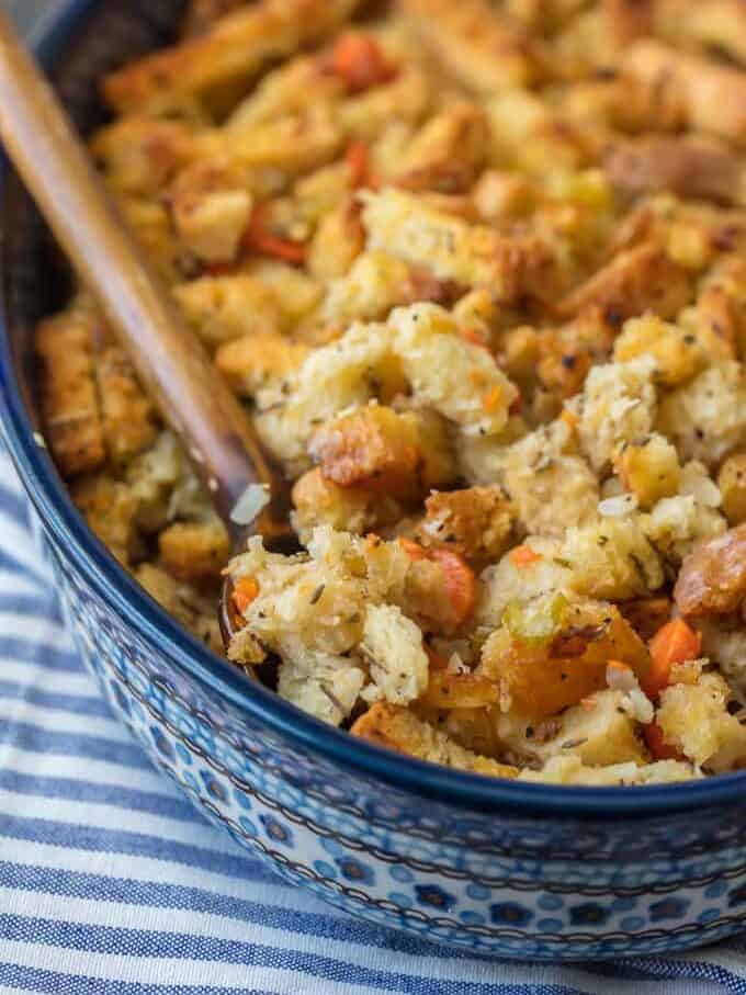 close up of a spoonful of dressing in a blue baking dish.