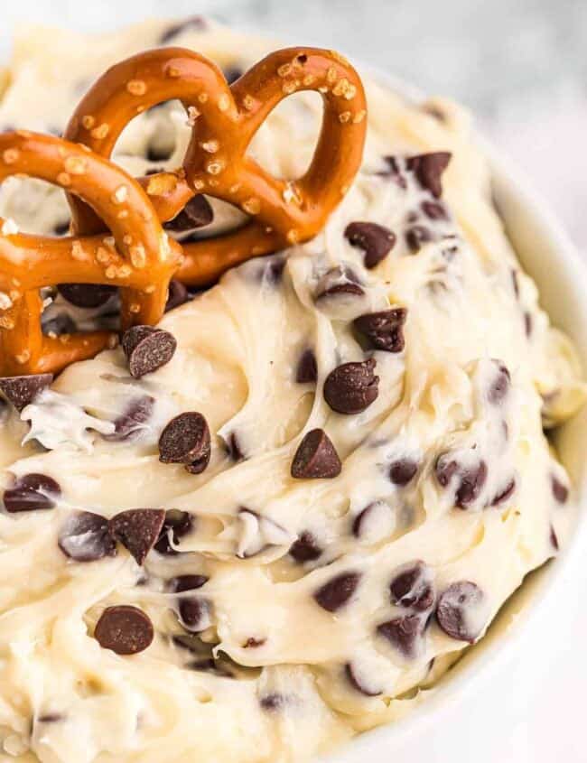 up close image of chocolate chip cookie dough dip with pretzels