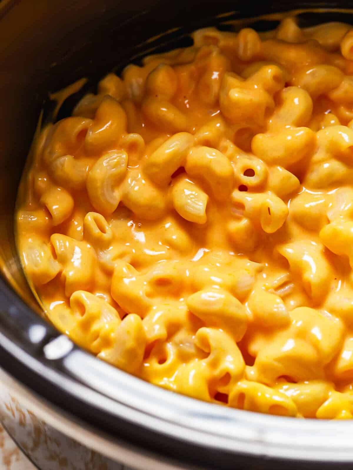 Crock Pot Mac and Cheese is a super simple recipe! This easy slow cooker macaroni and cheese makes the perfect side dish or weeknight dinner. It's virtually fool proof and comes out extra creamy and extra cheesy every time. Mac n cheese is always one of the best cheesy comfort foods around! macaroni and cheese in a crockpot.