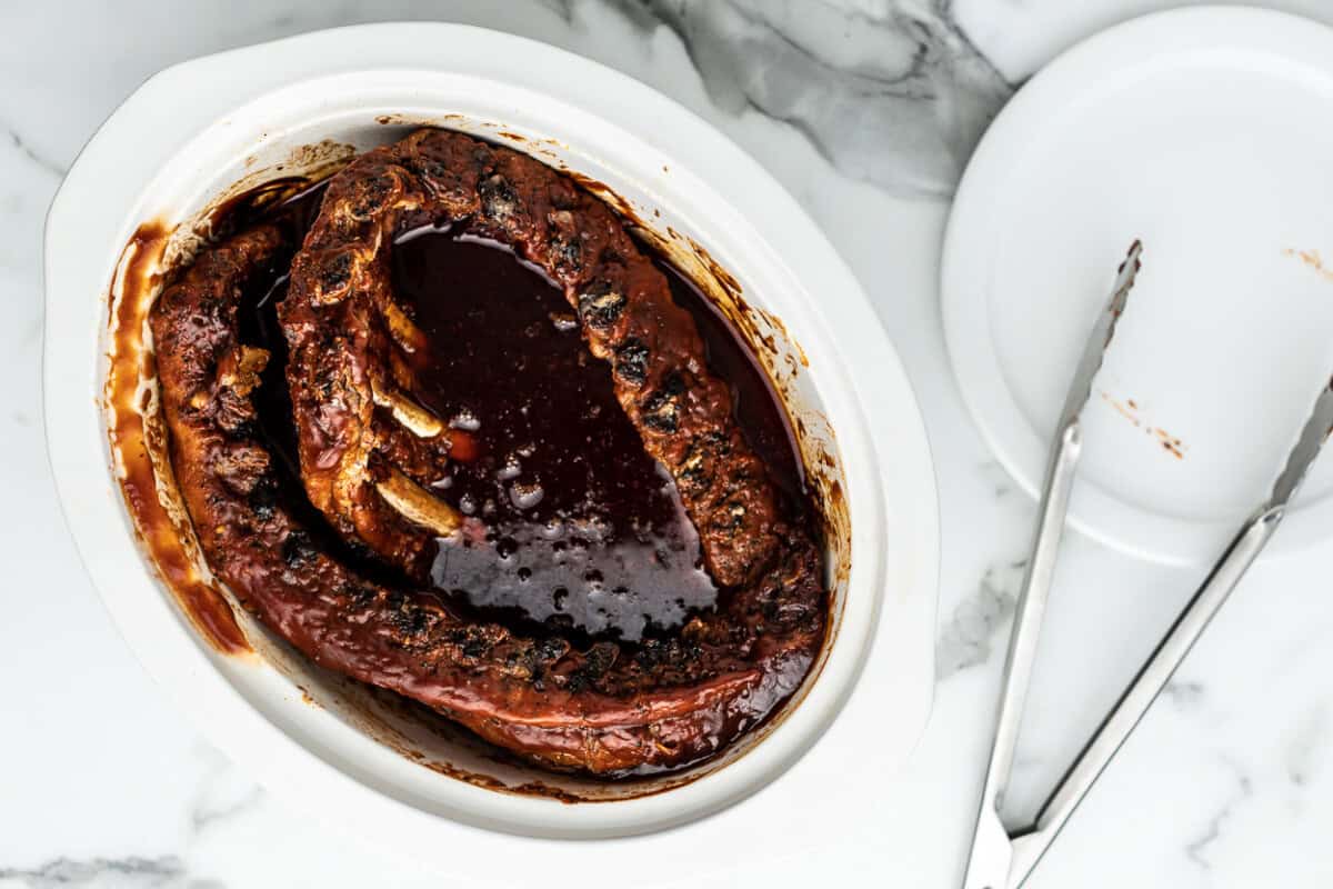 Slow cooker ribs in a white dish.