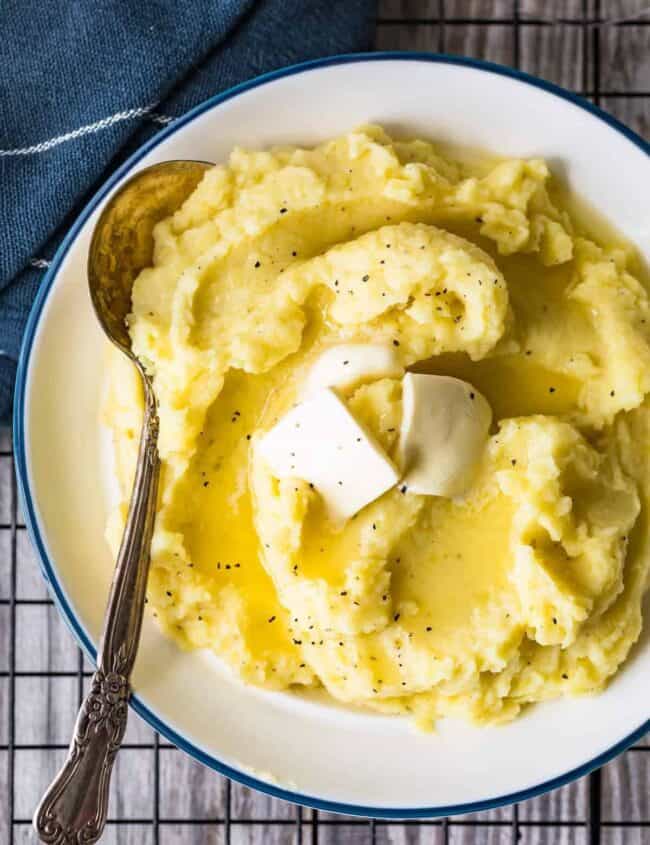 creamy mashed potatoes in a bowl with butter and a spoon