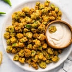 A plate of fried okra with dipping sauce.
