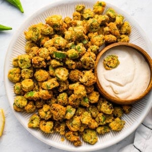 A plate of fried okra with dipping sauce.