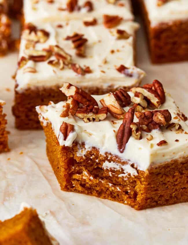 Pumpkin bars with cream cheese frosting and pecans.