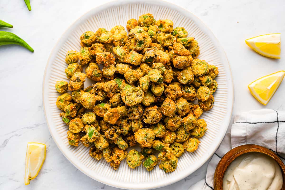 A plate of breaded fried okra with dipping sauce.