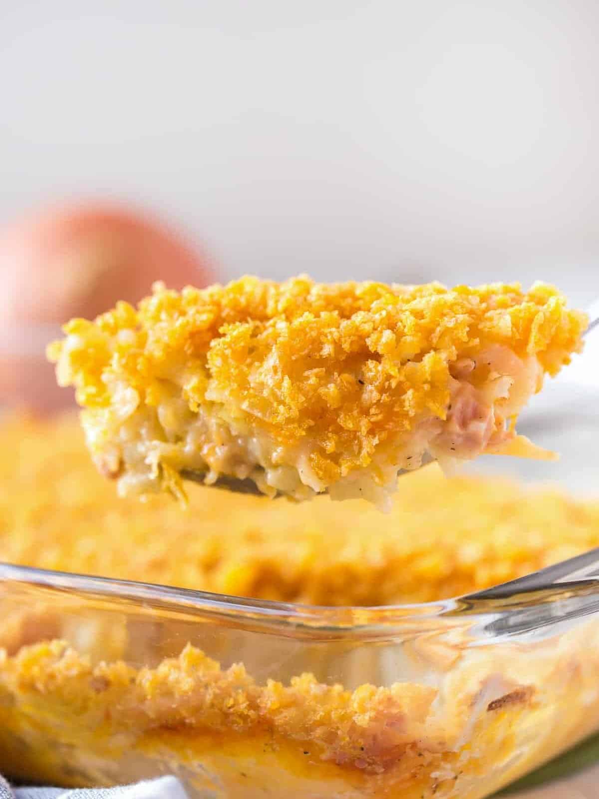 lifting up spoonful of funeral potatoes