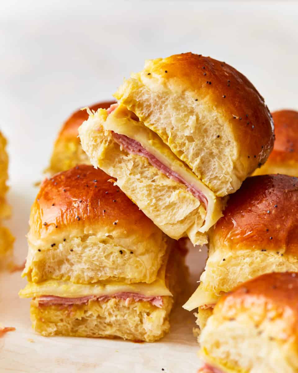 Ham and cheese sliders on a cutting board.