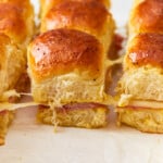Ham and cheese sliders on a baking sheet.