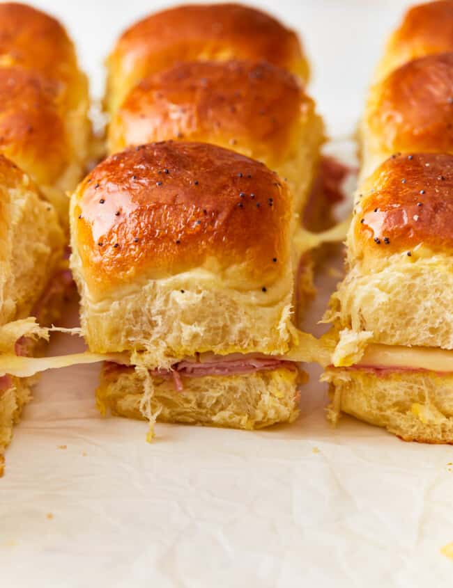 Ham and cheese sliders on a baking sheet.