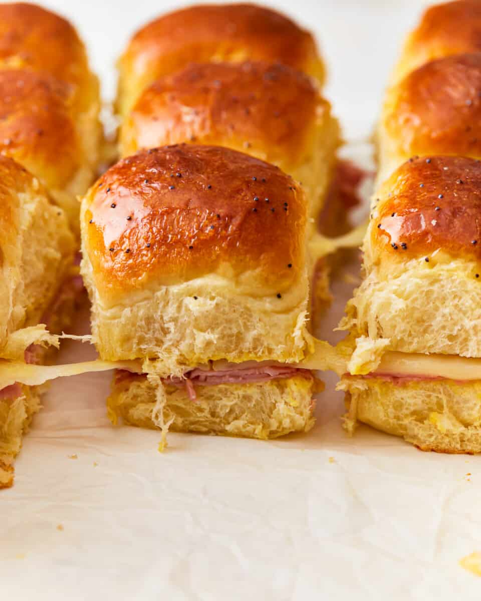 Ham and cheese sliders on a baking sheet.