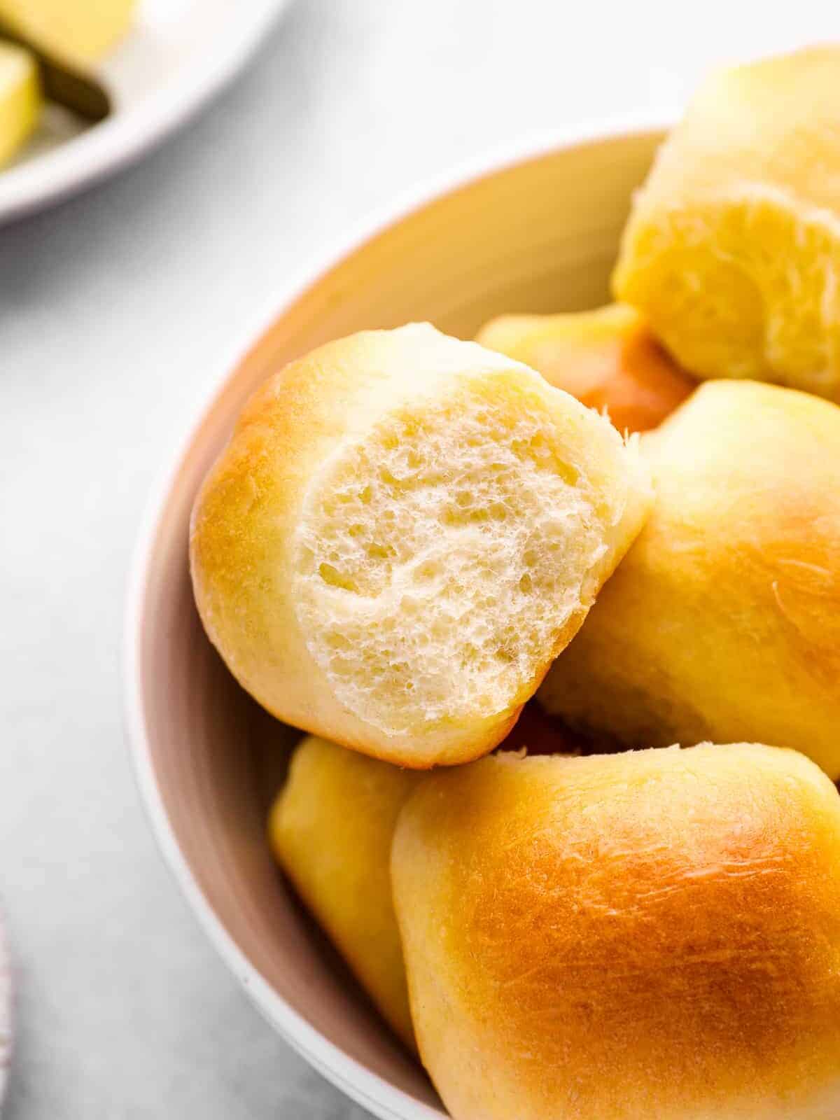 close up of rolls in a white bowl.