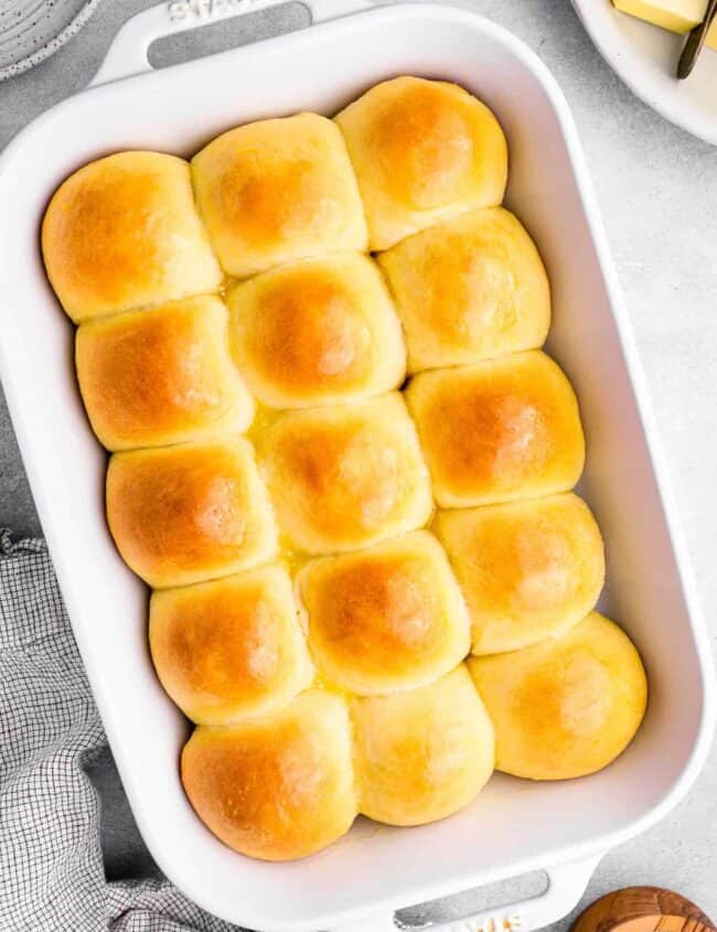 overhead view of 15 dinner rolls in a white baking dish.