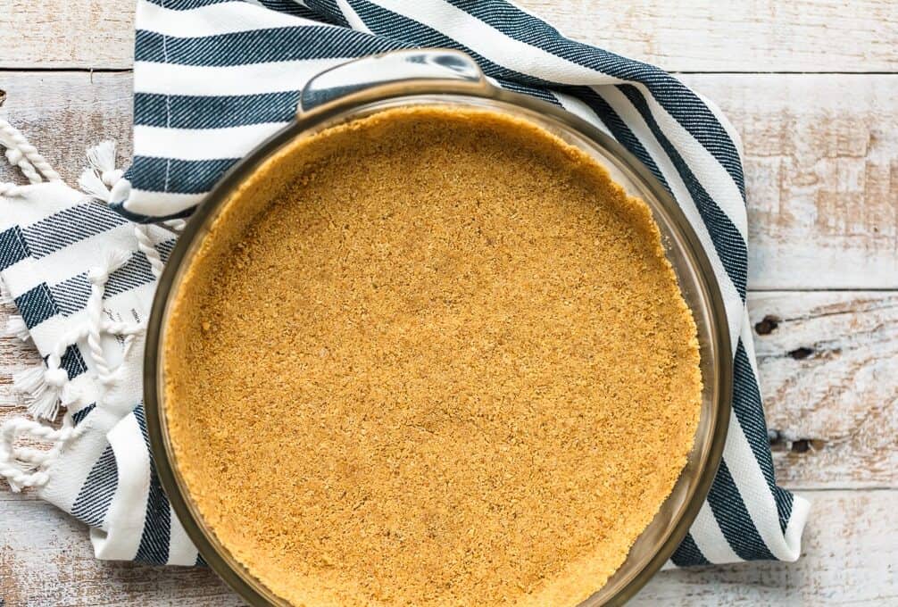 overhead view of graham crackers pressed into a glass pan.