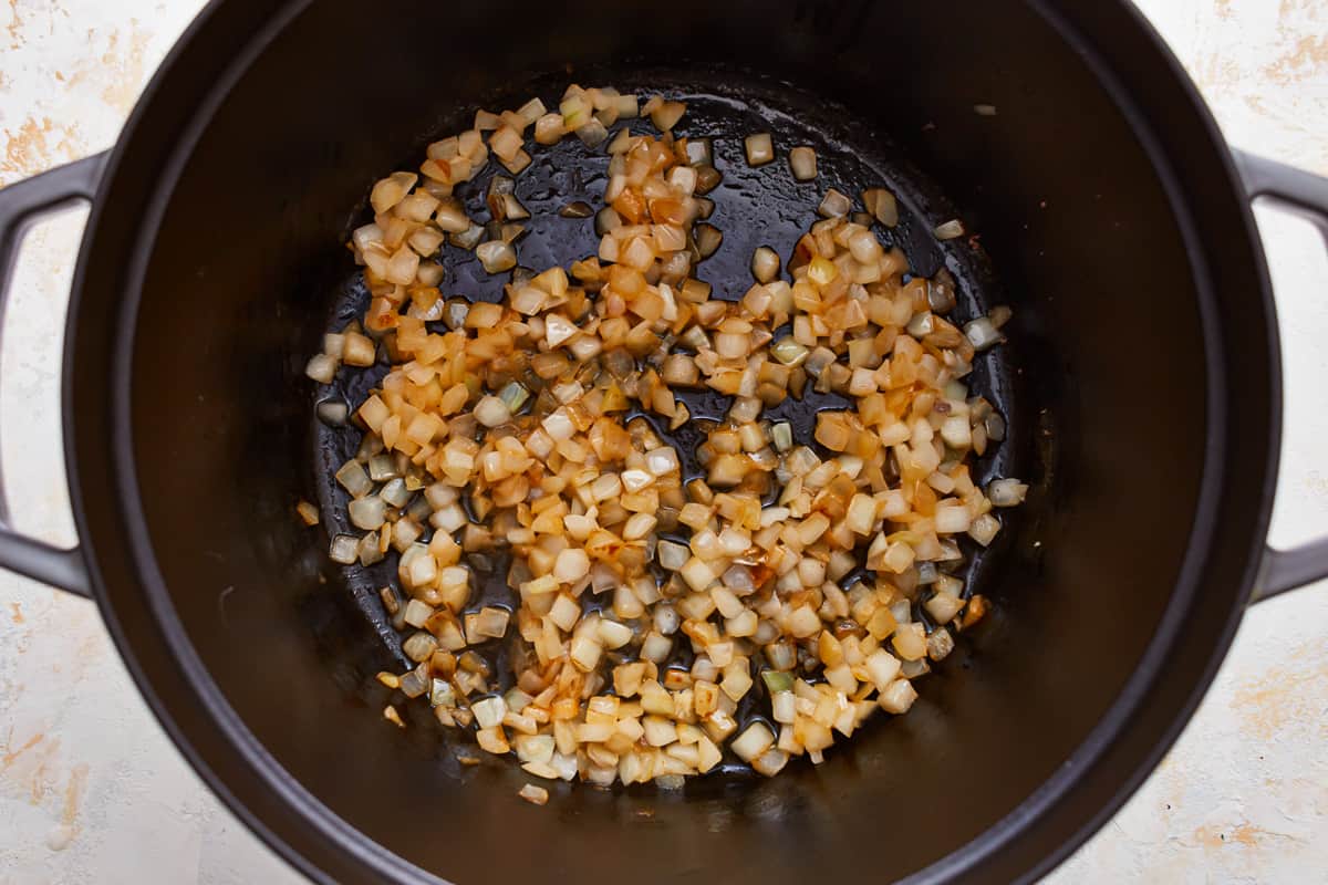 A pot with onions and garlic in it.