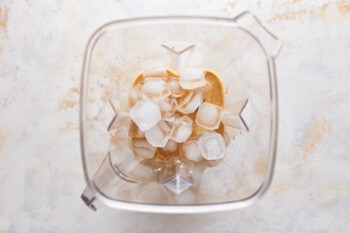 Ice cubes in a blender on a white background.