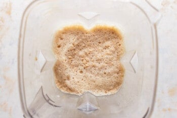A blender filled with a mixture of Frappuccino ingredients.