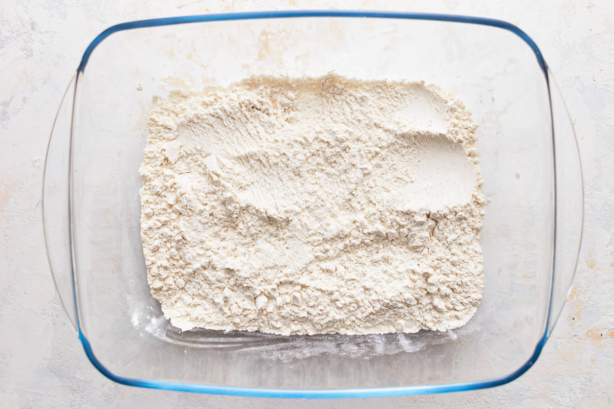 Seasoned flour mixture in a glass dish.
