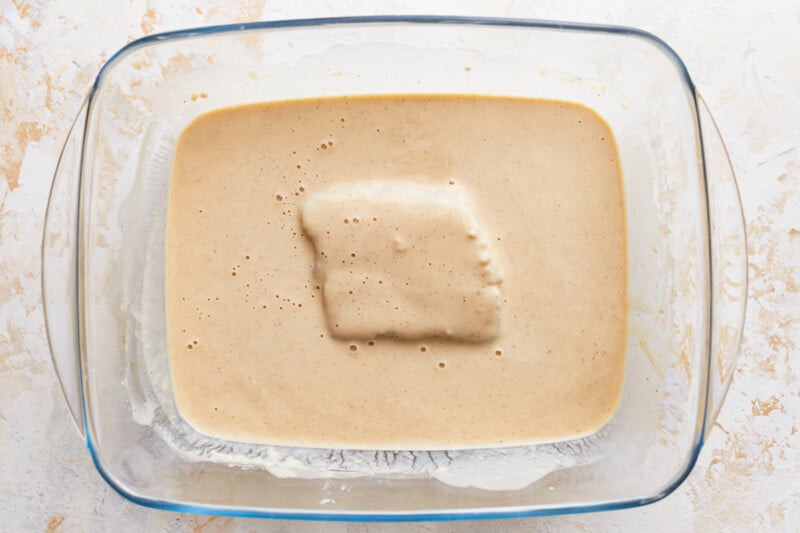 A square of batter in a glass baking dish.