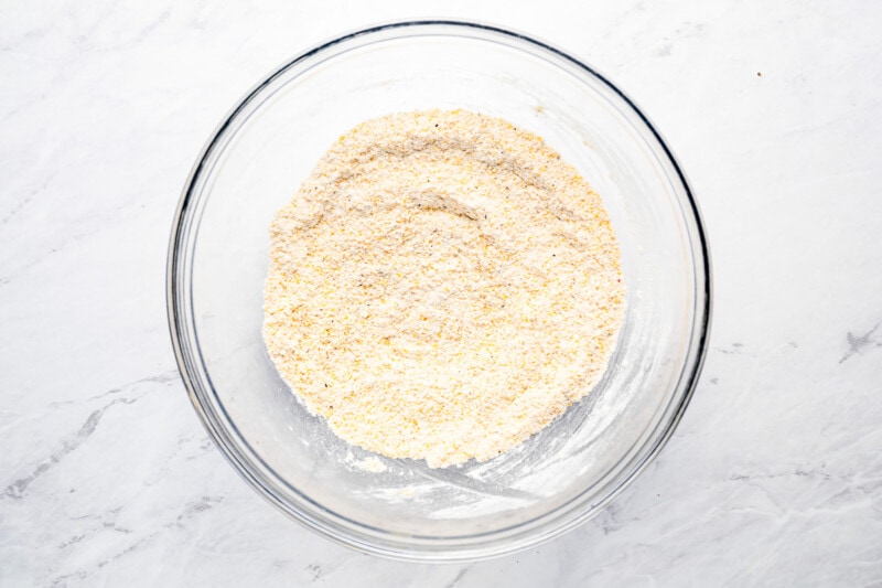 A glass bowl filled with granulated sugar.