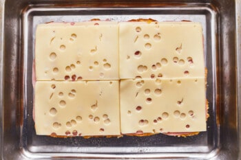 A square of cheese on top of a metal pan.