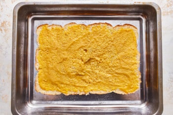 A piece of toast in a baking pan.