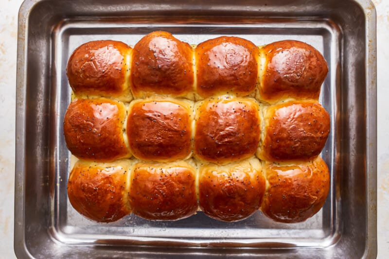 Buns in a baking pan on a white background.