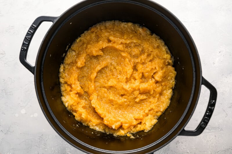 A slow cooker filled with mashed potatoes.