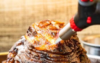using a kitchen torch to caramelize honey baked ham