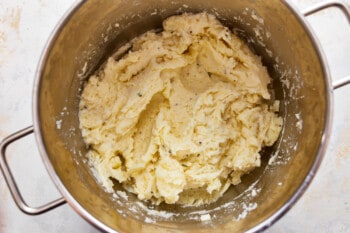 Mashed potatoes in a metal bowl.