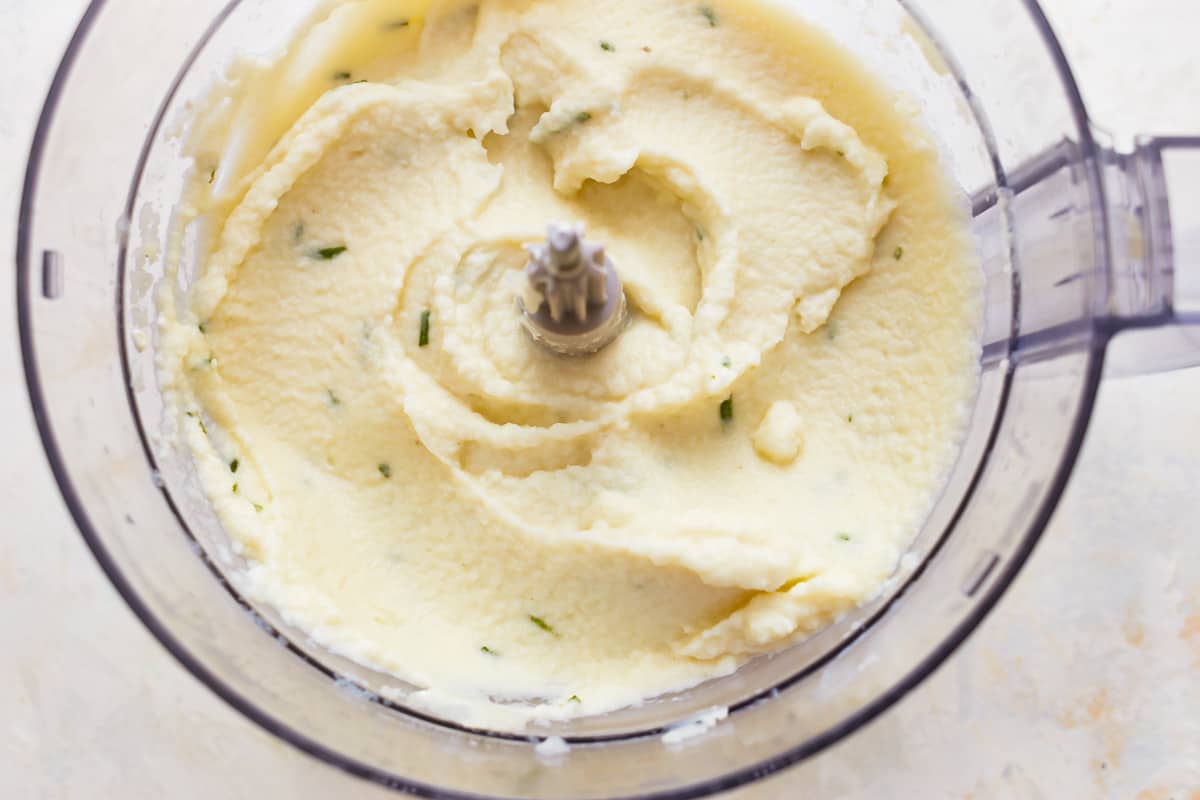 pureeing cauliflower in a food processor to make cauliflower mash.