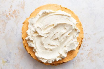 A pumpkin pie with whipped cream on top.