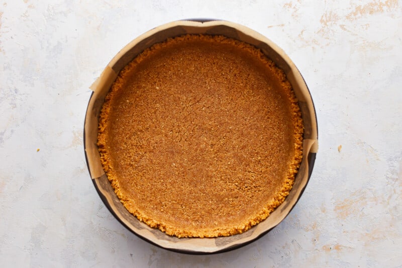 A pie crust in a pan on a table.
