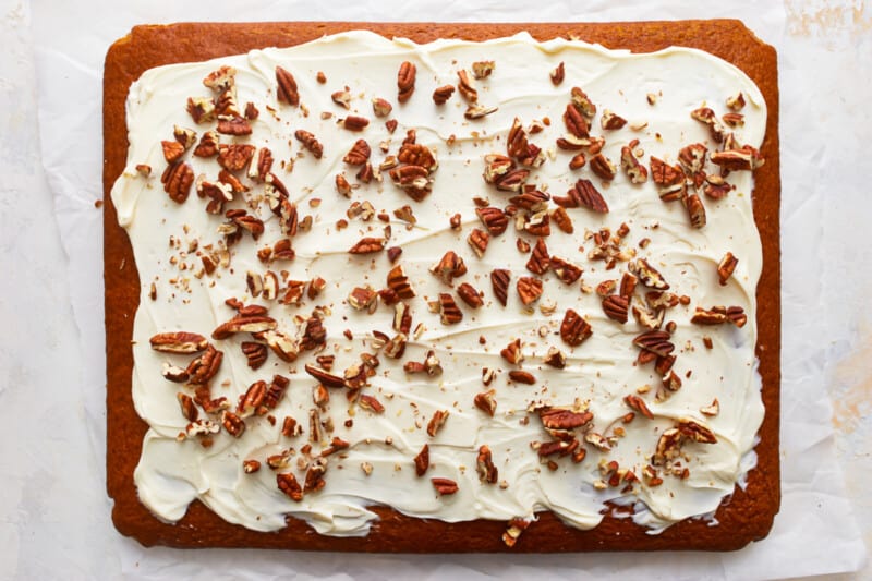 Pumpkin bars with icing and pecans on it.