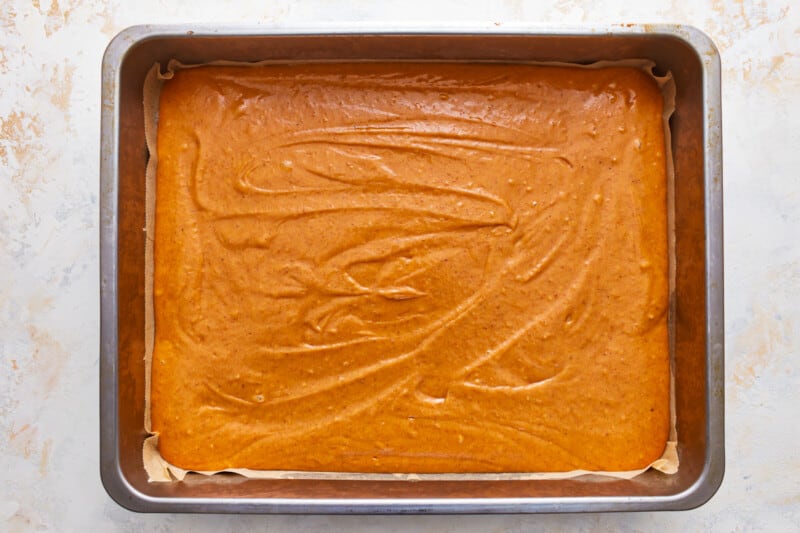 A baking pan with a pumpkin cake in it.