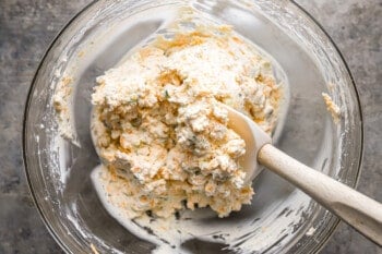 A glass bowl with a wooden spoon in it.