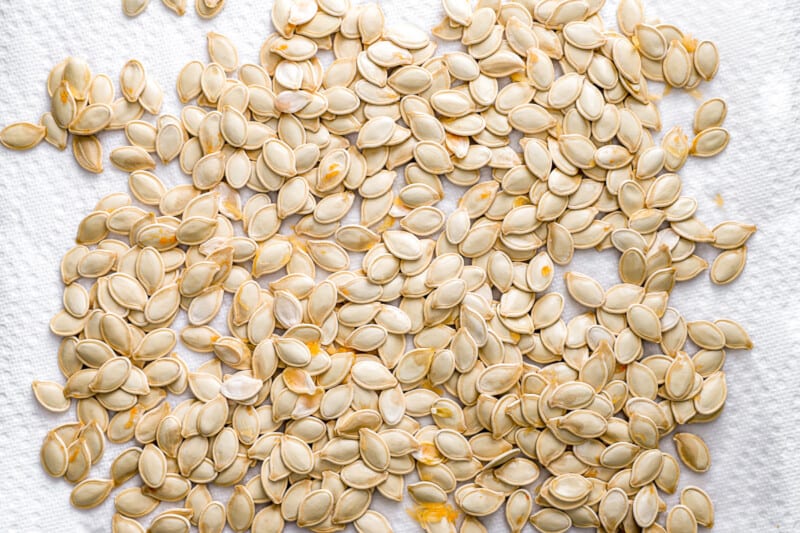 Pumpkin seeds on a white towel.