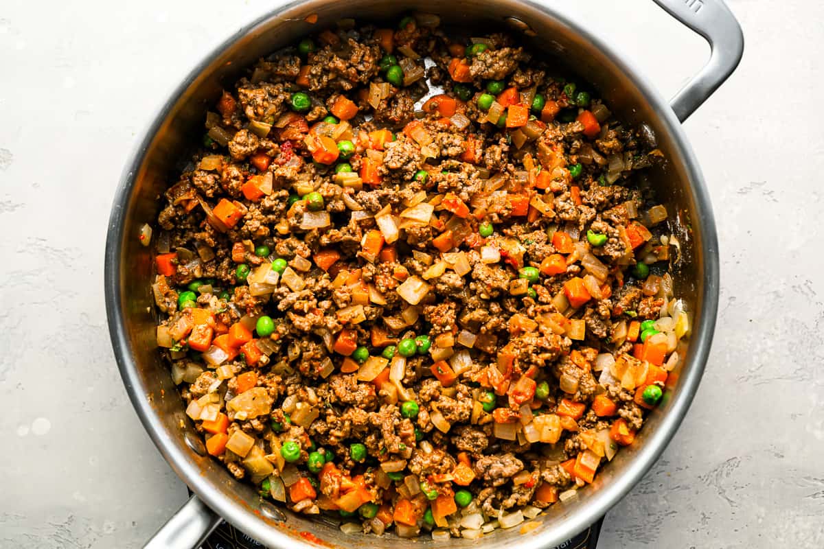 A pan with meat and vegetables in it.