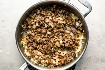 A skillet filled with ground beef and onions.