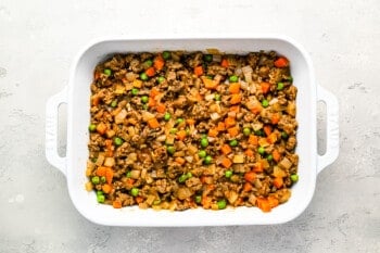 A casserole dish filled with vegetables and meat.