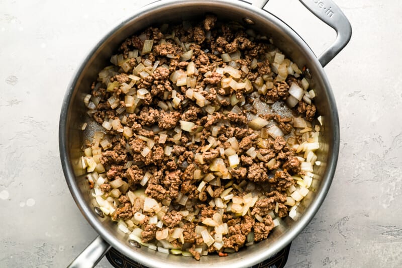 A skillet filled with ground beef and onions.