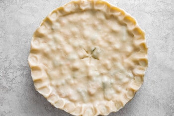 A close up of a pie crust on a concrete surface.