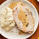 Turkey with gravy and mashed potatoes on a plate.