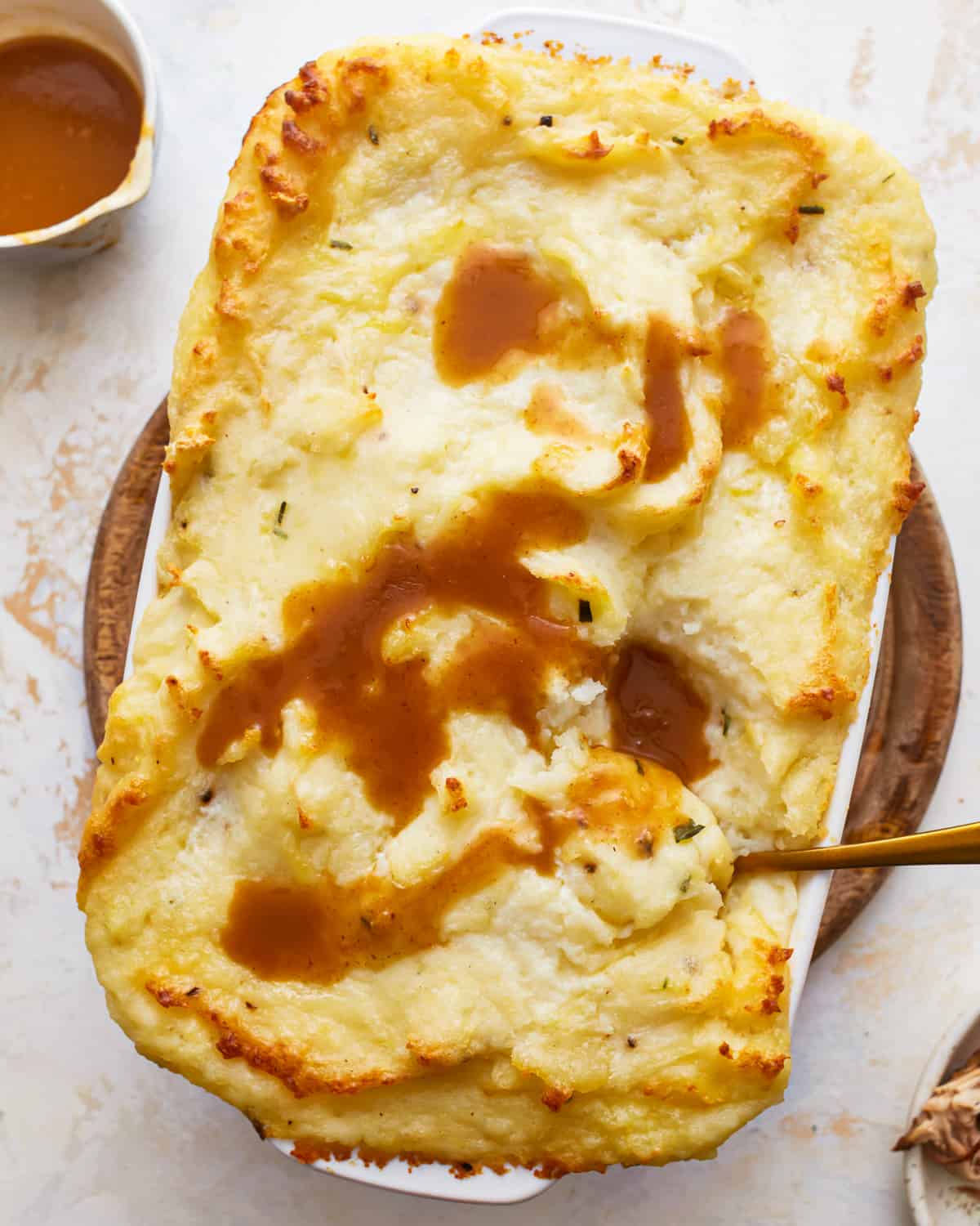 Make ahead mashed potatoes in a casserole dish, topped with gravy.