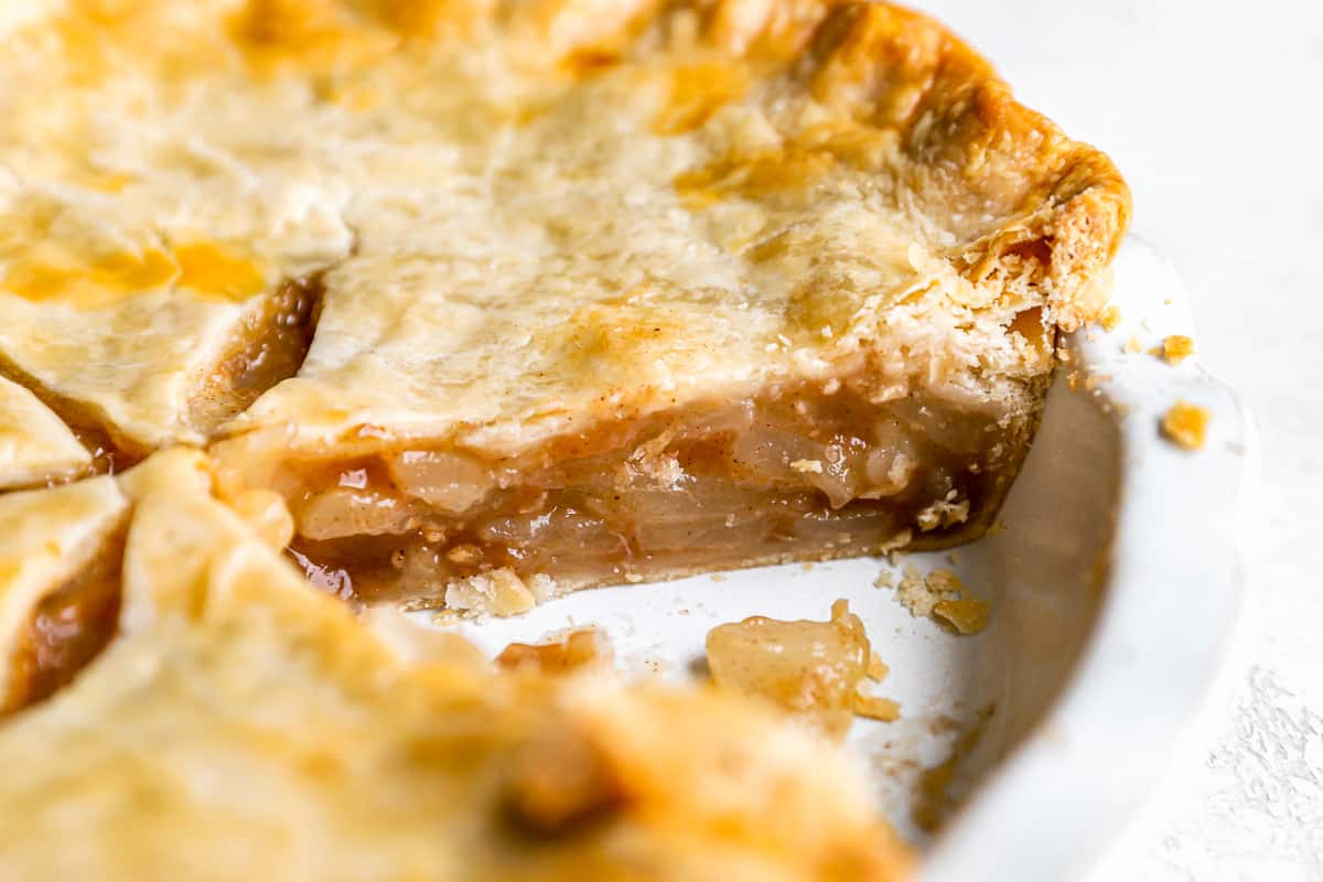 A slice of pear pie on a white plate.