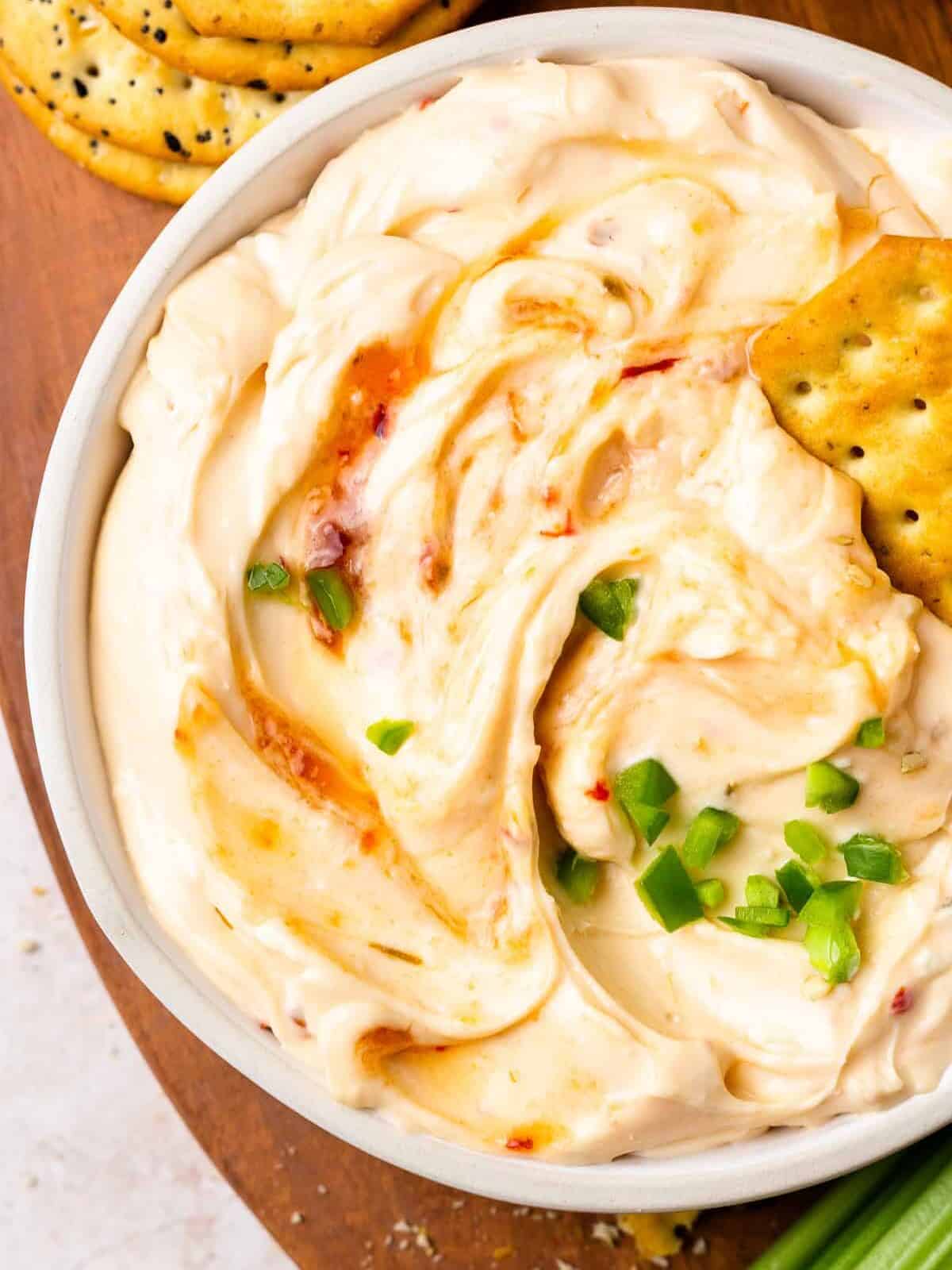 close up on a bowl of a cream cheese pepper jelly dip