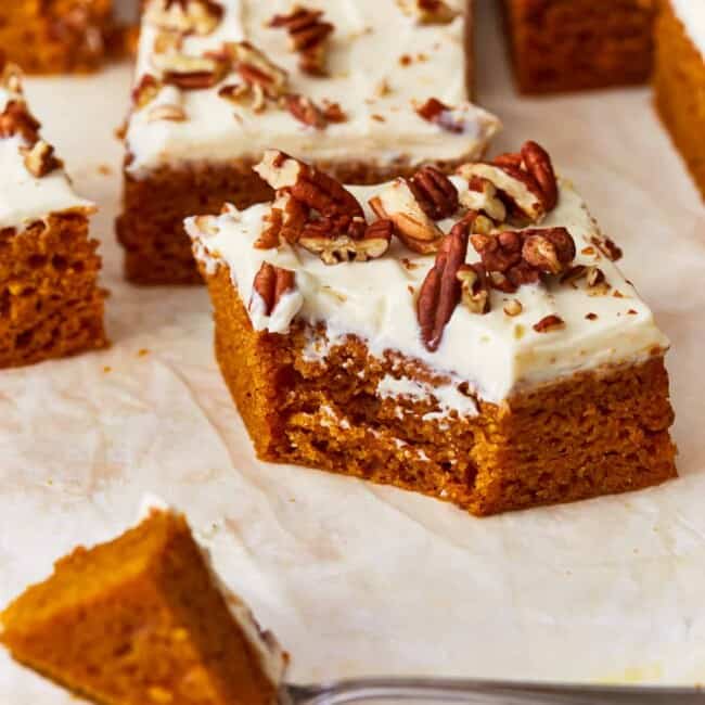 Pumpkin bars with cream cheese frosting and pecans.